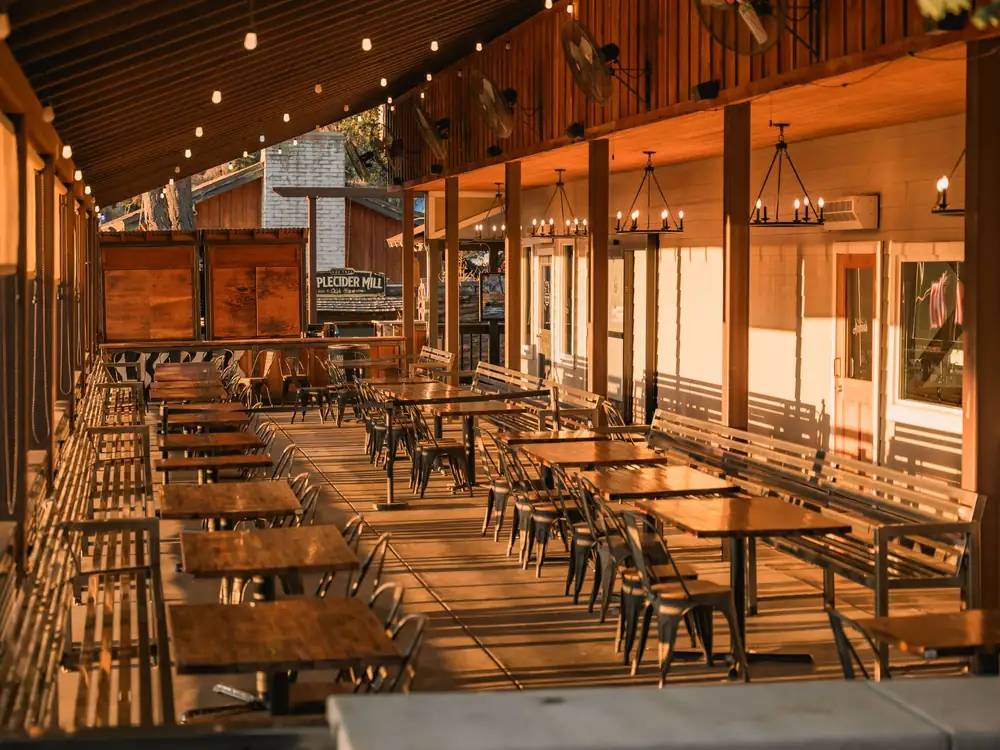 A covered wooden patio in golden evening light